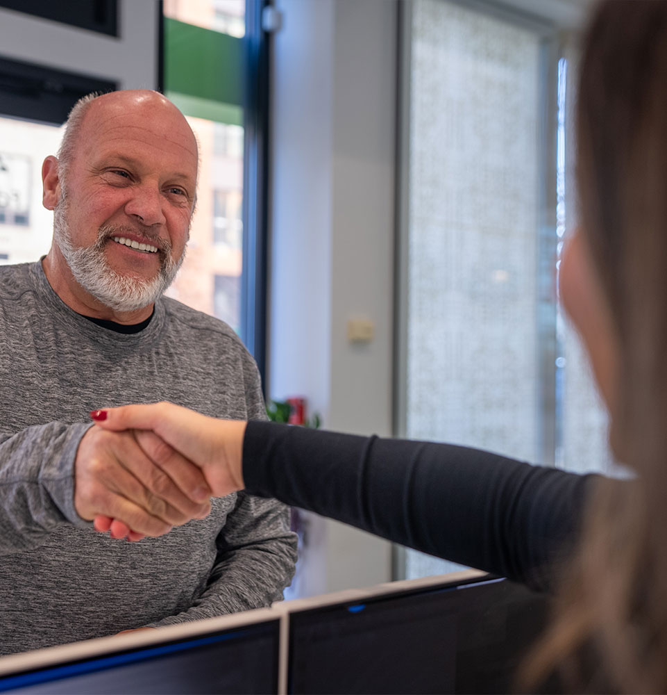 patient shaking team members hand